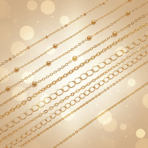 Gold chains of different styles on a white background

