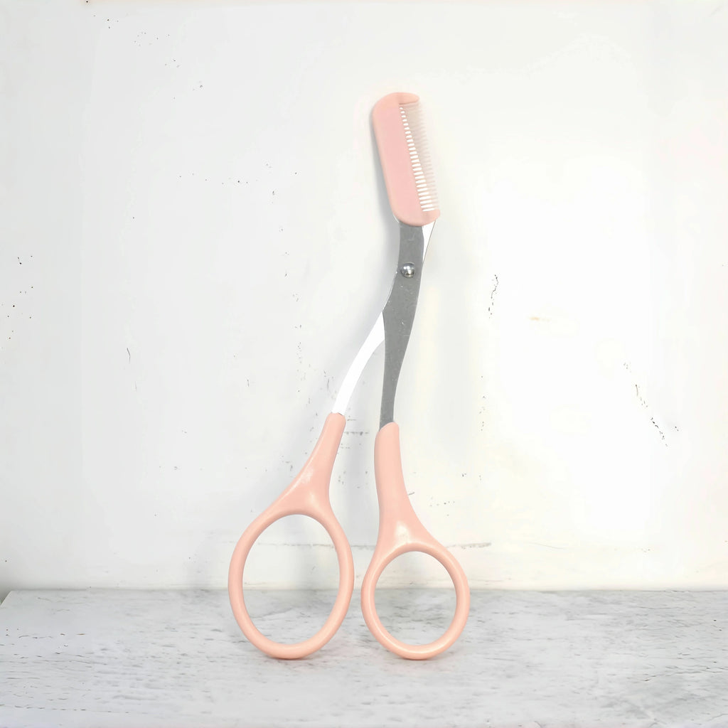 Pink eyebrow trimming scissors with built-in comb